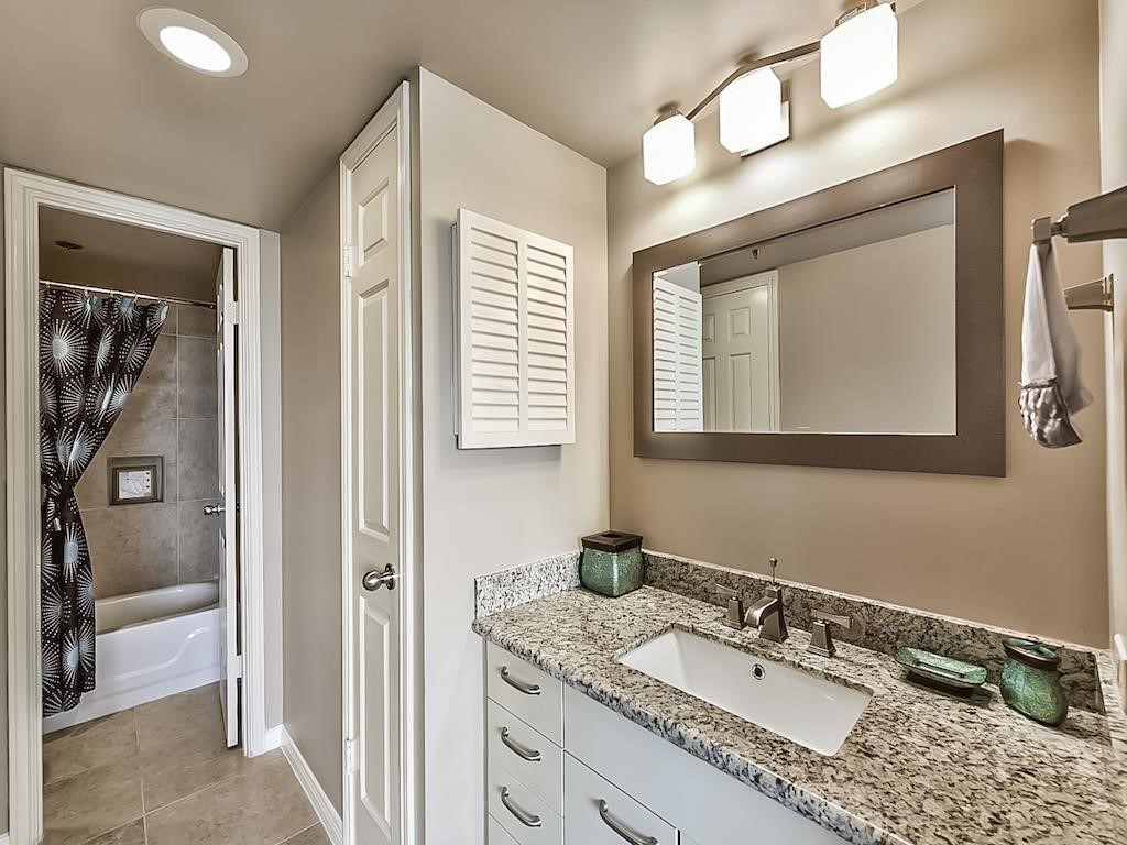 3525 Sage Road, Unit 704 Houston, TX 77056 - Photo 23 of 29 a bathroom with a granite countertop sink mirror and vanity