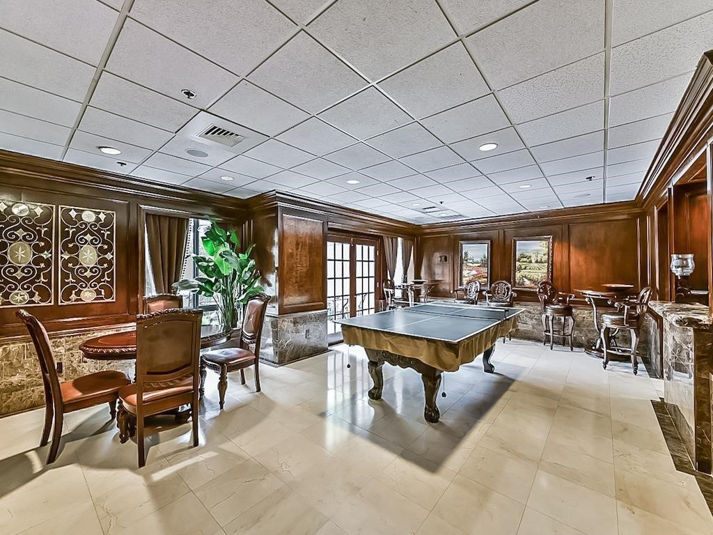 3525 Sage Road, Unit 704 Houston, TX 77056 - Photo 28 of 29 a dining room with furniture a rug a potted plant and a large window