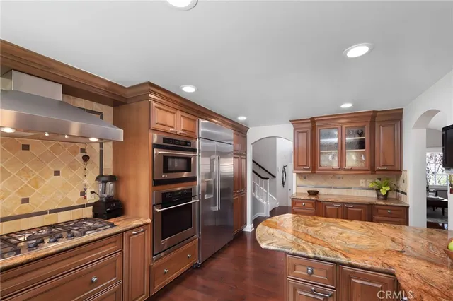 a kitchen with a sink appliances and cabinets