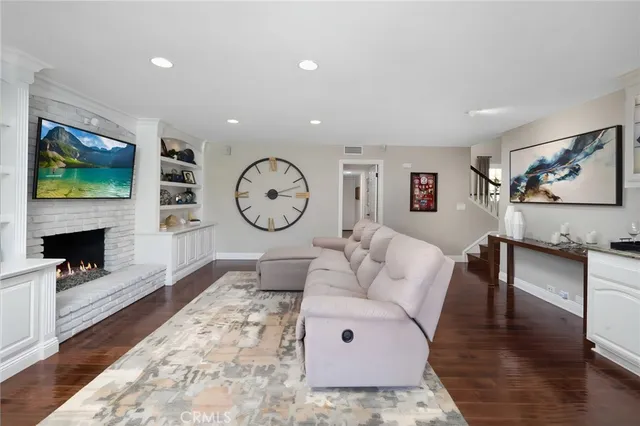a living room with fireplace furniture and a flat screen tv