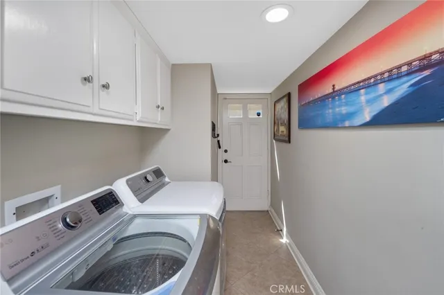 a bathroom with a double vanity sink mirror and shower