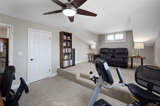 a living room with furniture gym equipment and a window