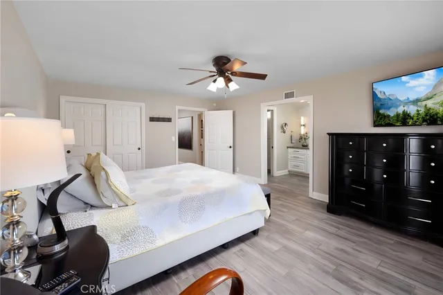 a bedroom with a bed and wooden floor