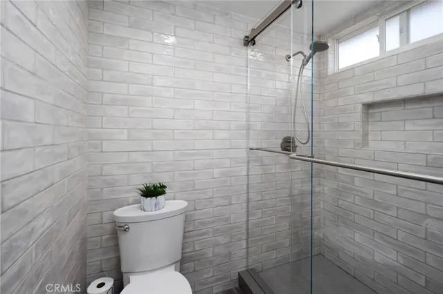 a bathroom with a double vanity sink toilet and shower