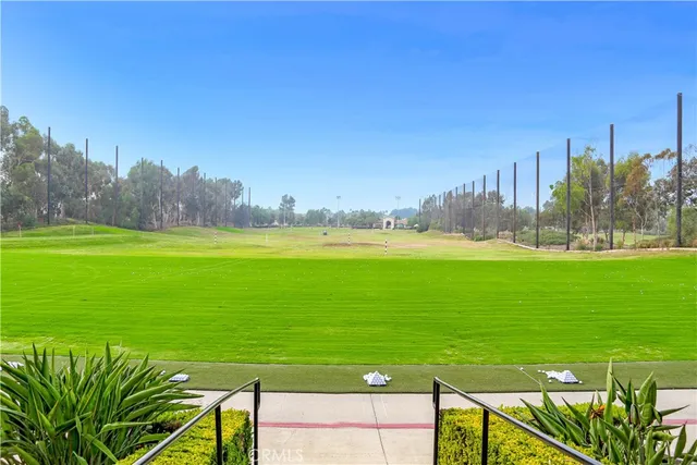 a view of a brick house with a clock tower in the middle