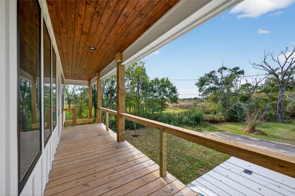 a view of balcony with wooden floor and fence