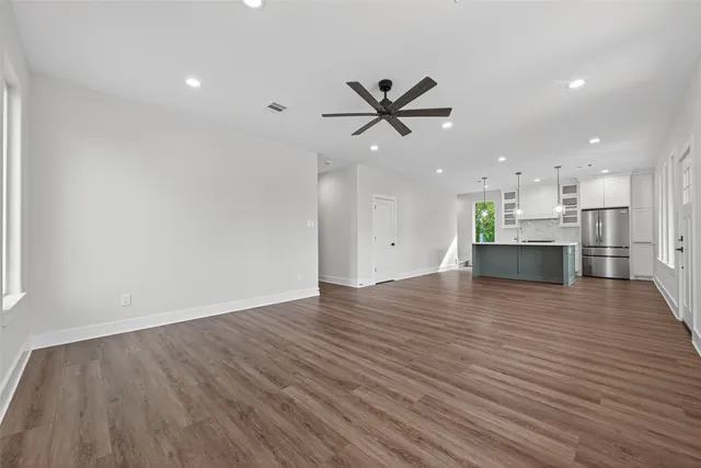 a view of a kitchen with a sink and wooden floor