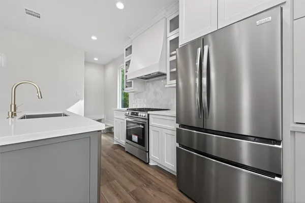 a kitchen with stainless steel appliances a refrigerator sink and stove