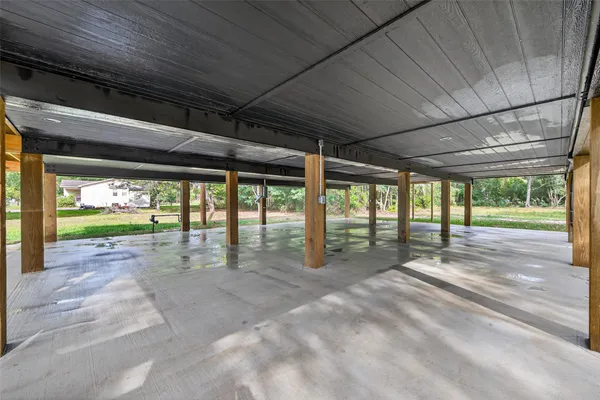 a room with wooden stairs and a large window