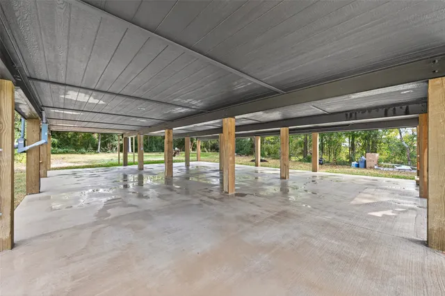 a view of a livingroom with a window wooden floor and a ceiling fan