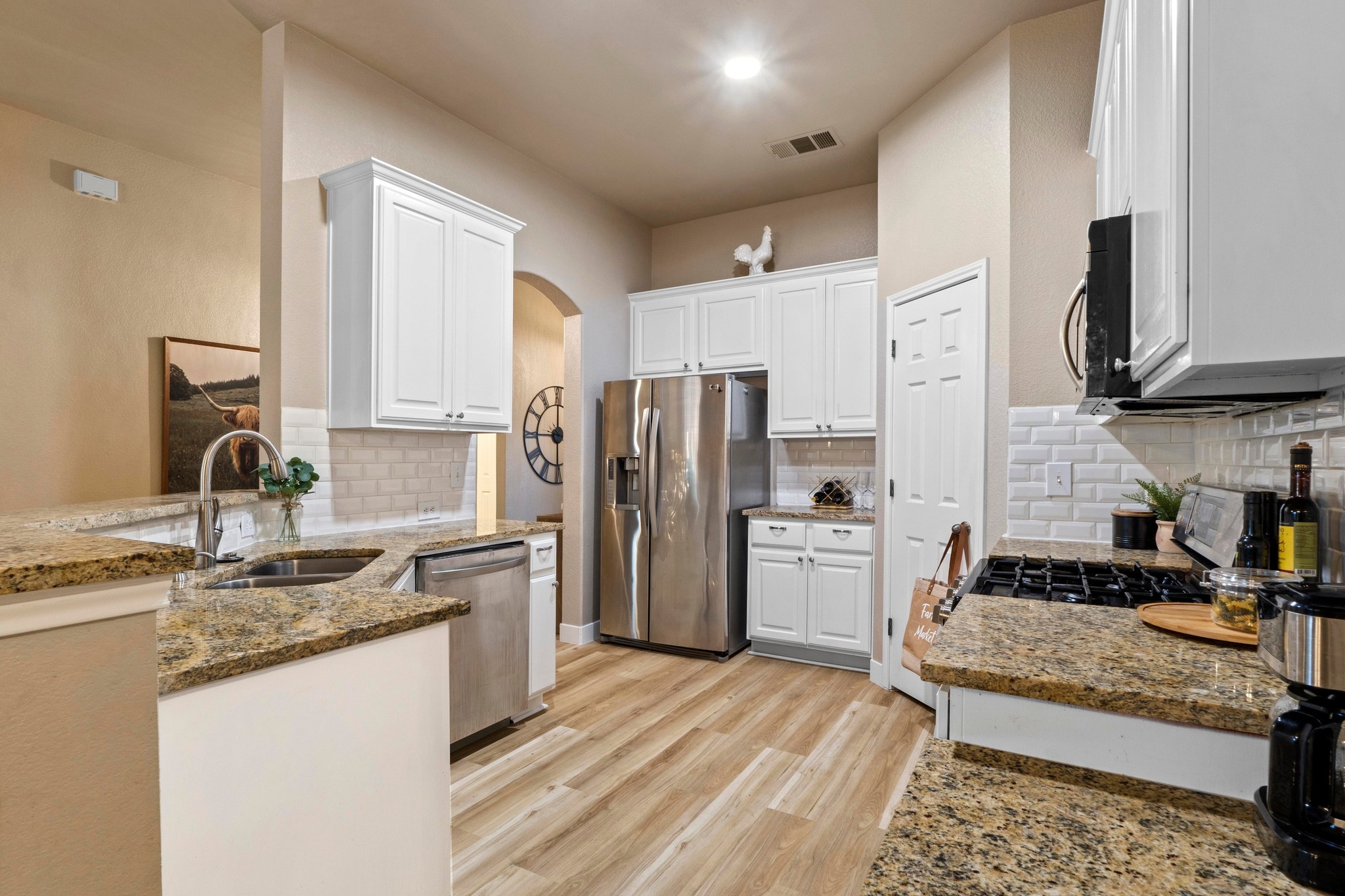 1020 Portchester Castle Path Pflugerville, TX 78660 - Photo 13 of 29 The kitchen is complete with granite countertops, stainless steel appliances, and a lovely subway tile backsplash throughout.