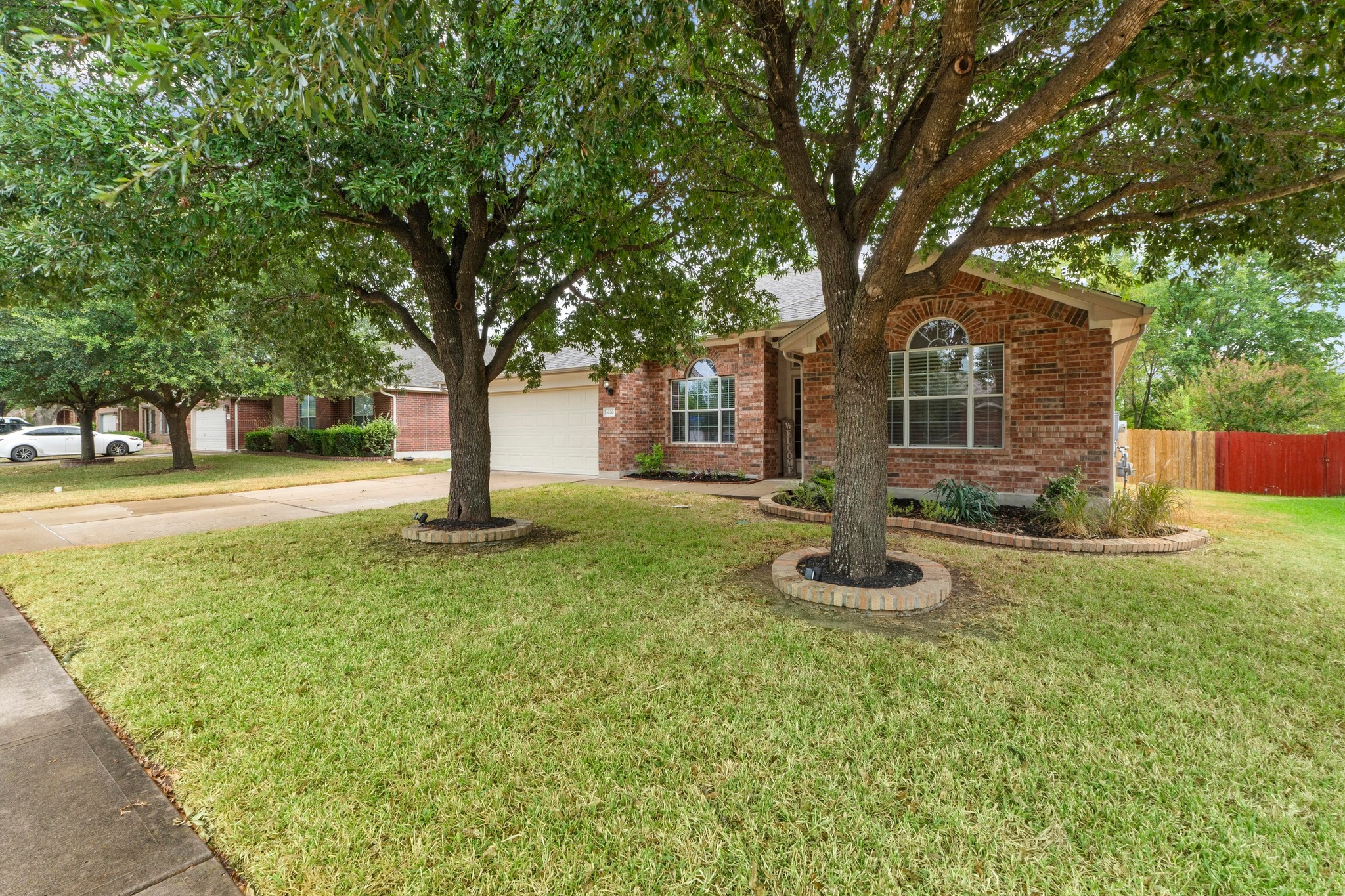 1020 Portchester Castle Path Pflugerville, TX 78660 - Photo 6 of 29 Twin trees grace the well-groomed front yard and provide great shade, making it easy to sit out and wave to passing neighbors.