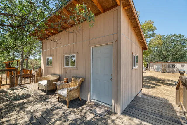 a backyard of a house with outdoor seating