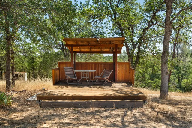 a view of swimming pool with a patio and wooden fence