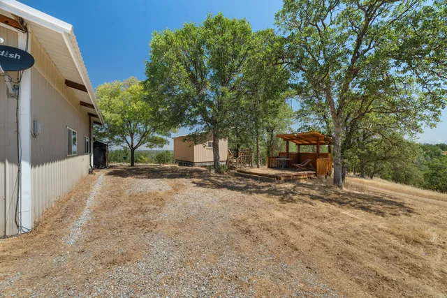 a view of a house with backyard and sitting area