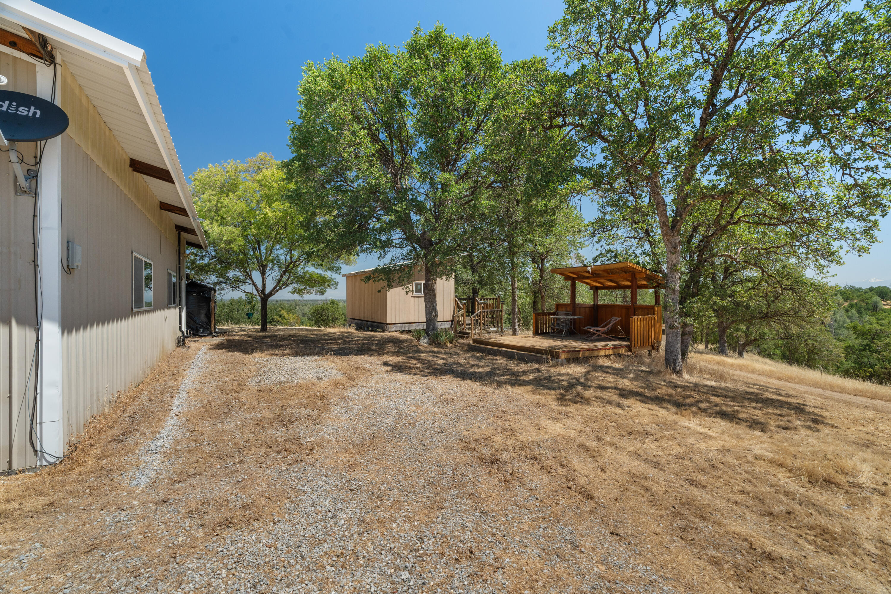 16720 Blue Oak Road Cottonwood, CA 96022 - Photo 22 of 35 a view of a house with backyard and sitting area