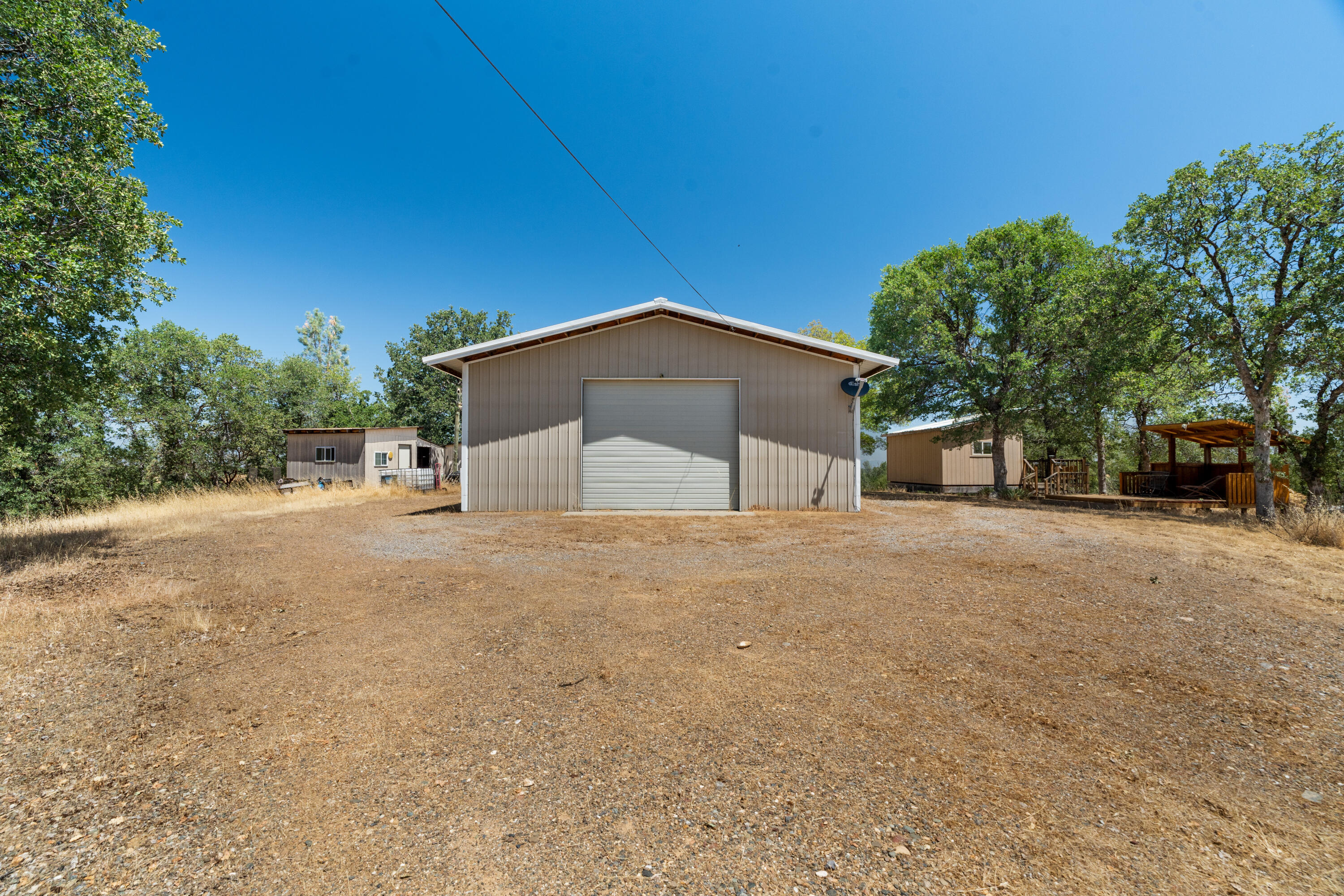 16720 Blue Oak Road Cottonwood, CA 96022 - Photo 5 of 35 a house with trees in front of it