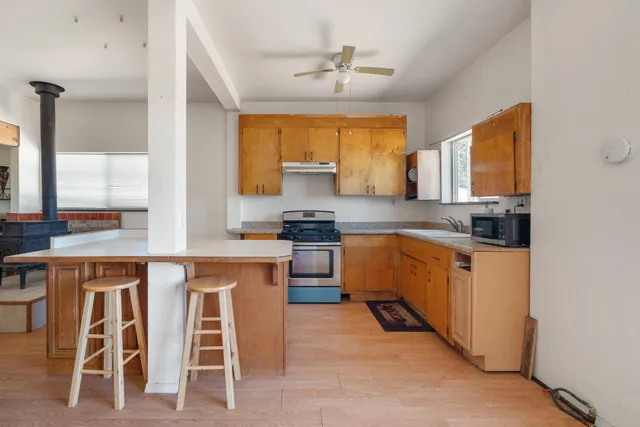a kitchen with granite countertop a sink counter top space and appliances