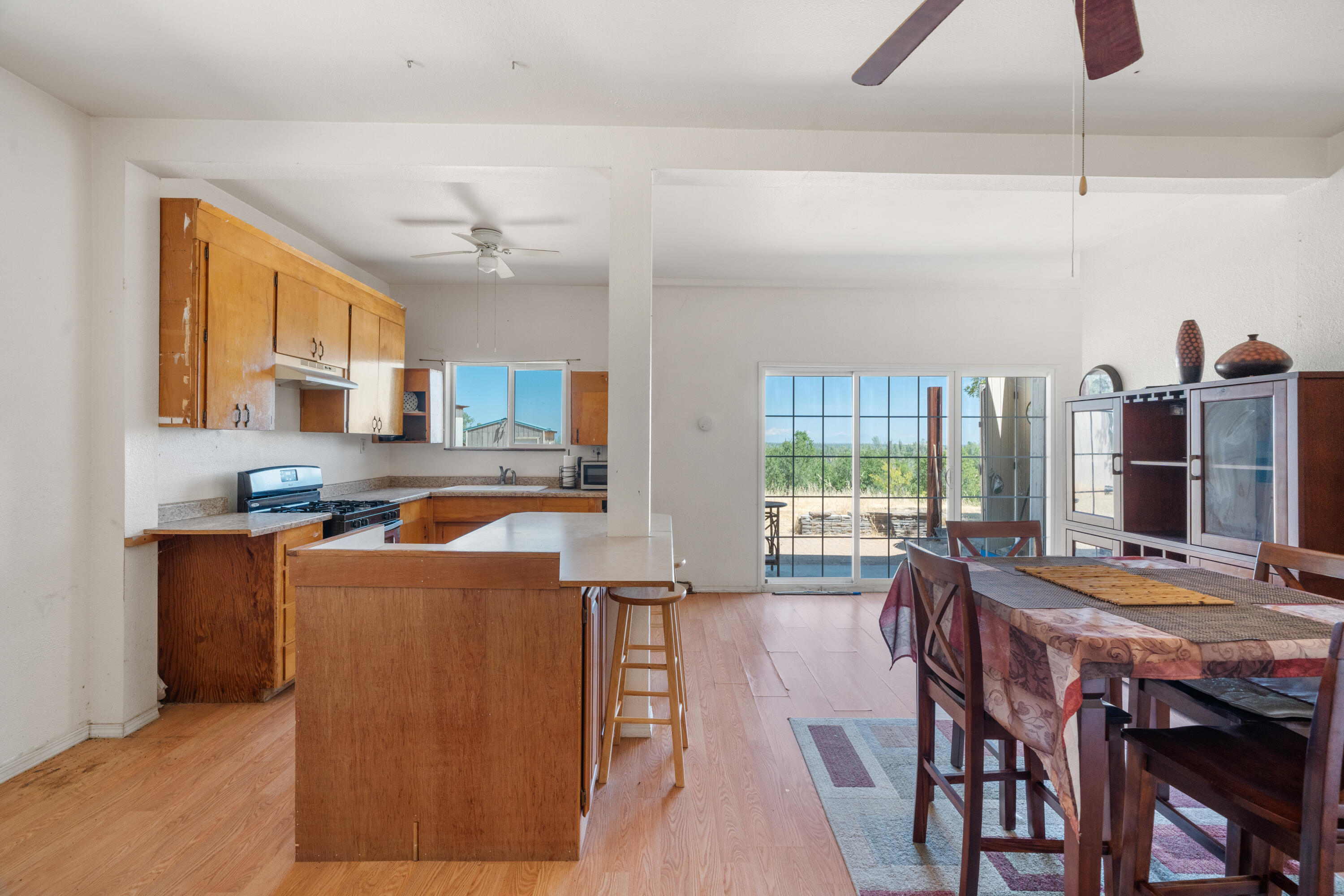 16720 Blue Oak Road Cottonwood, CA 96022 - Photo 9 of 35 a living room with stainless steel appliances furniture a chandelier wooden floor and a large window