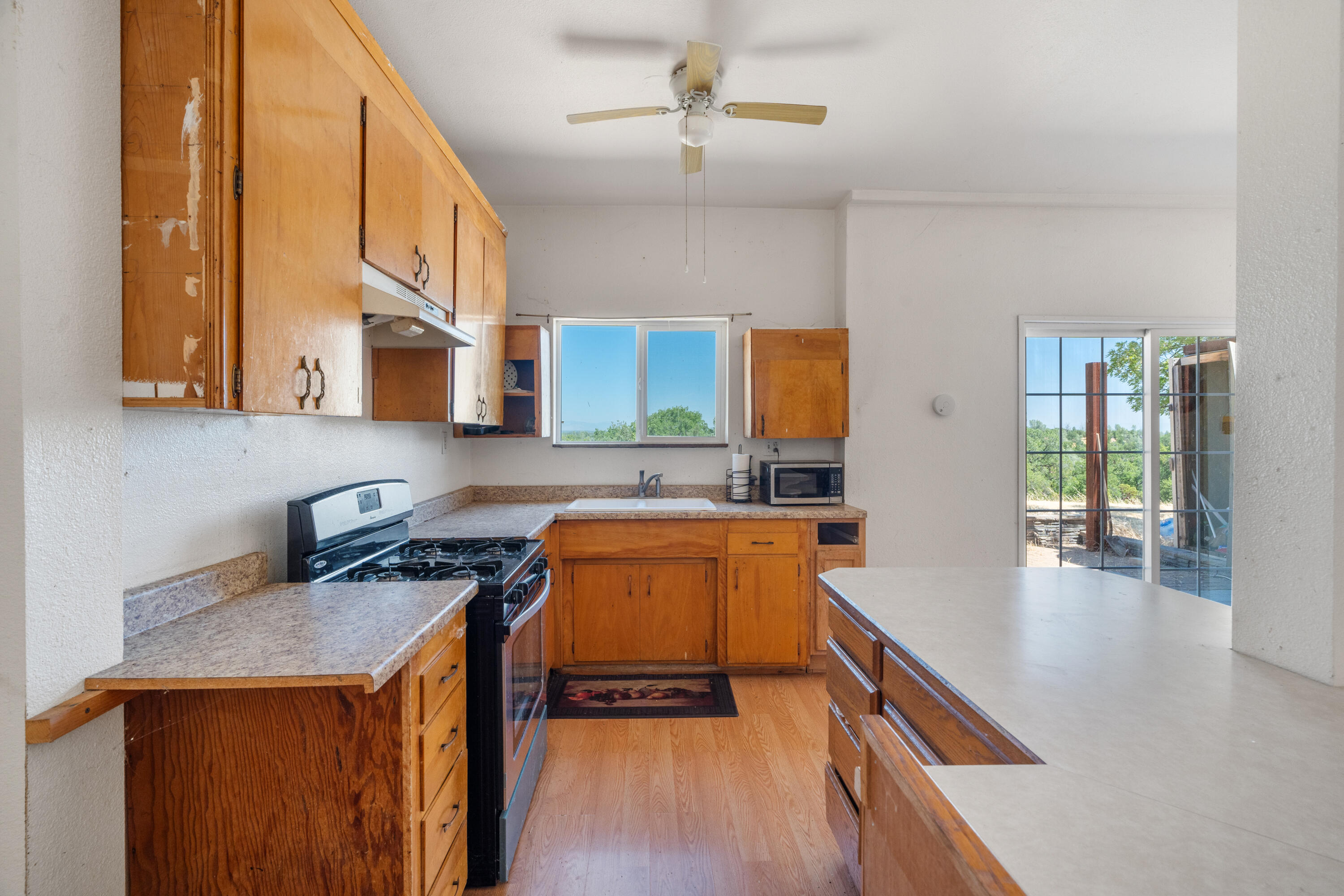 16720 Blue Oak Road Cottonwood, CA 96022 - Photo 10 of 35 a kitchen that has a sink a stove and cabinets
