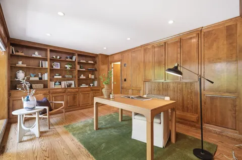 a room with a table chairs and a kitchen view