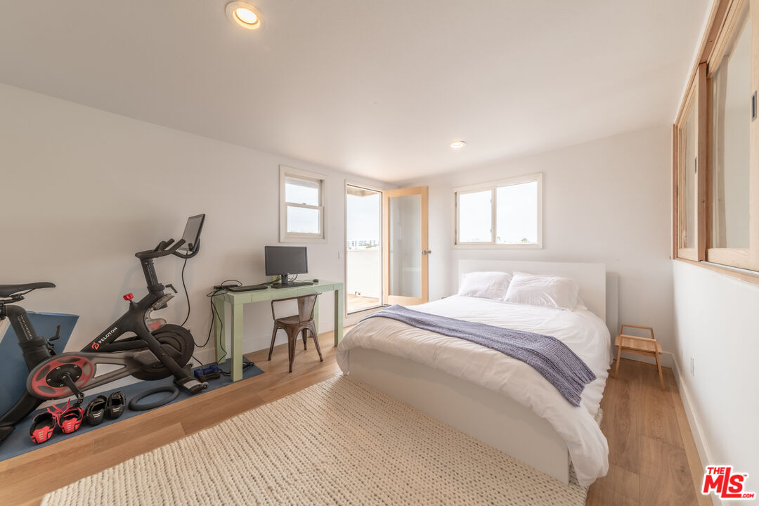 29 Lighthouse Street, Unit 3PH Venice, CA 90292 - Photo 12 of 25 a bedroom with a bed and a table