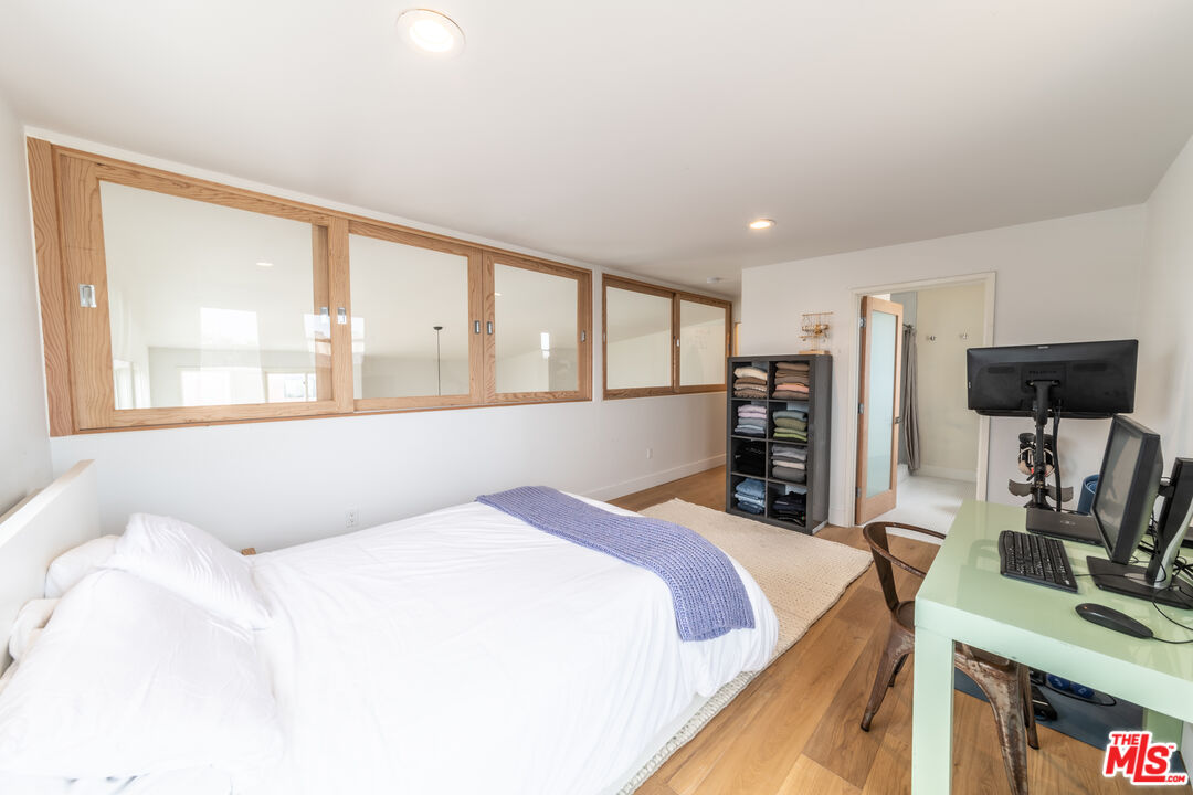 29 Lighthouse Street, Unit 3PH Venice, CA 90292 - Photo 13 of 25 a bedroom with a large bed and a flat tv screen on dresser