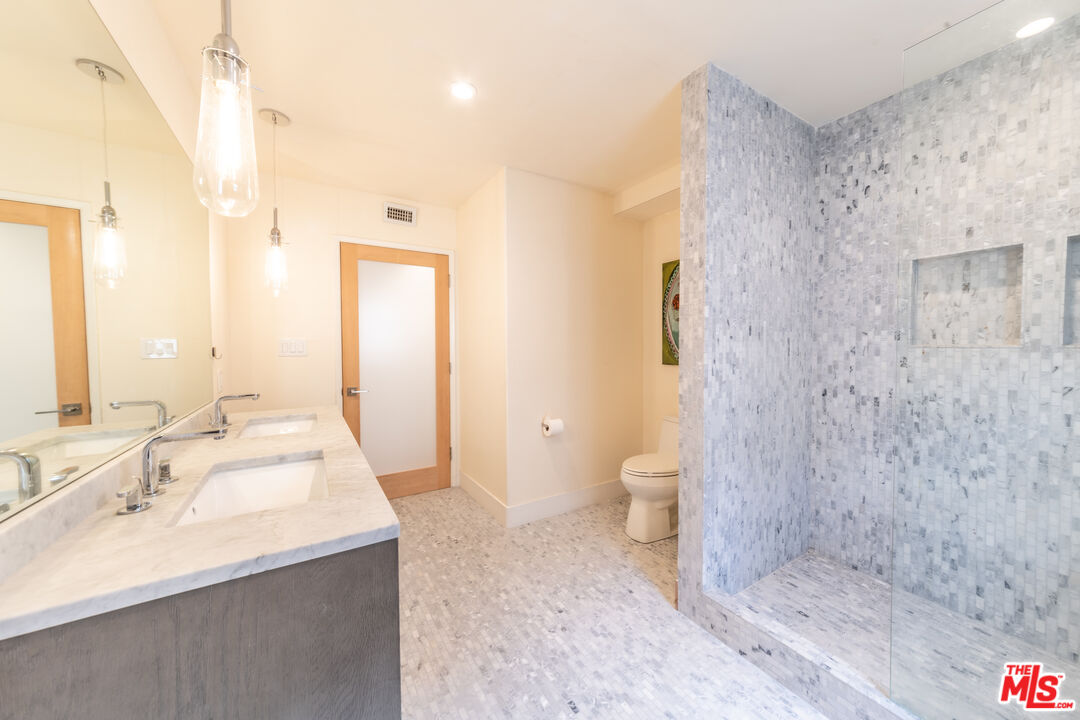 29 Lighthouse Street, Unit 3PH Venice, CA 90292 - Photo 15 of 25 a bathroom with a sink a toilet and shower