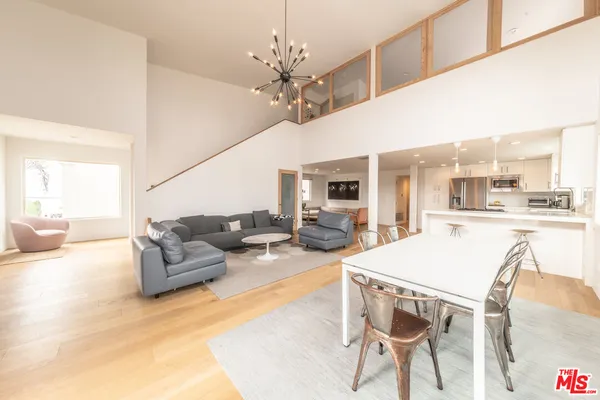 a living room with furniture and kitchen view