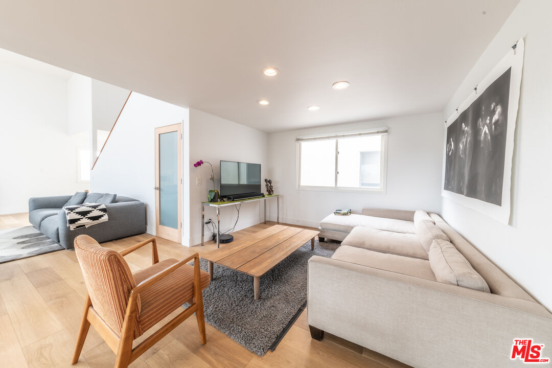 29 Lighthouse Street, Unit 3PH Venice, CA 90292 - Photo 8 of 25 a living room with furniture a flat screen tv and a window