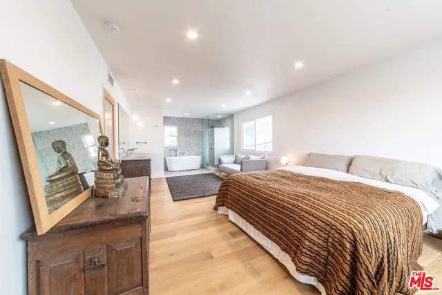 a spacious bathroom with a double vanity sink and a bathtub