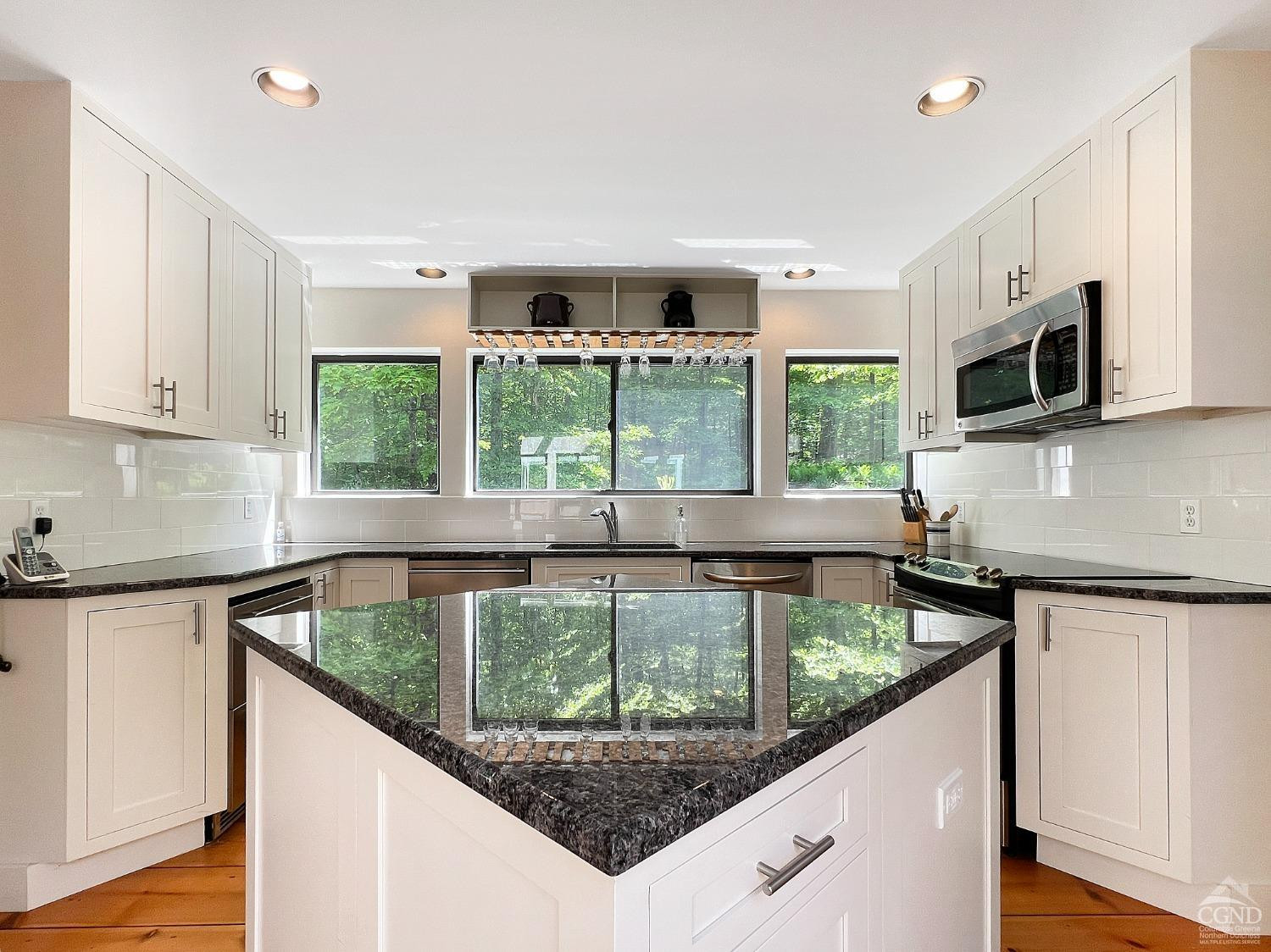 208 Cambridge Road Copake, NY 12529 - Photo 19 of 36 a kitchen with a stove a sink and a microwave