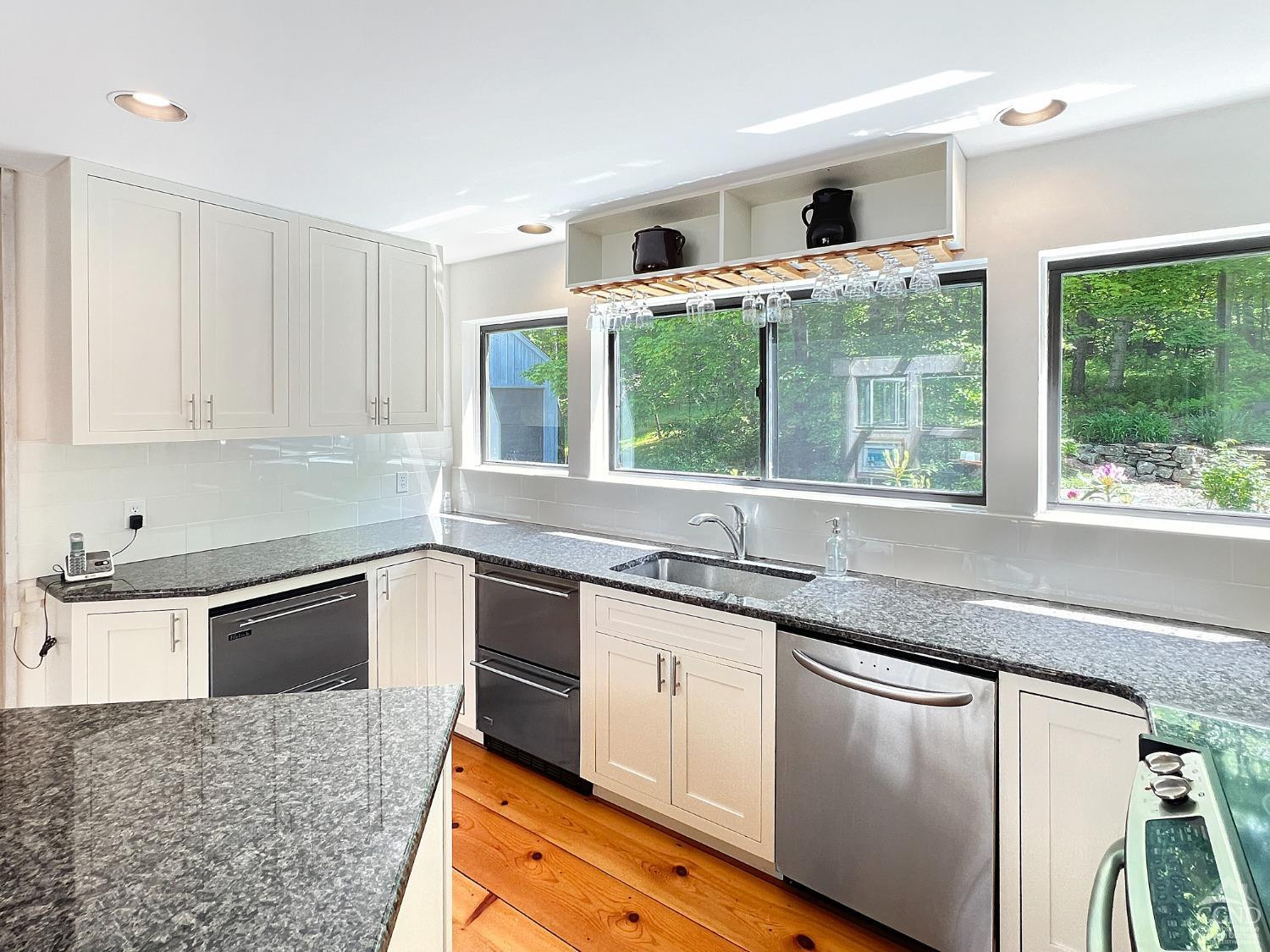208 Cambridge Road Copake, NY 12529 - Photo 20 of 36 a kitchen with granite countertop a sink and white cabinets