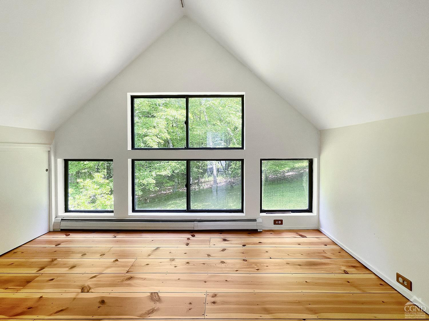 208 Cambridge Road Copake, NY 12529 - Photo 33 of 36 a view of an empty room with wooden floor and a window