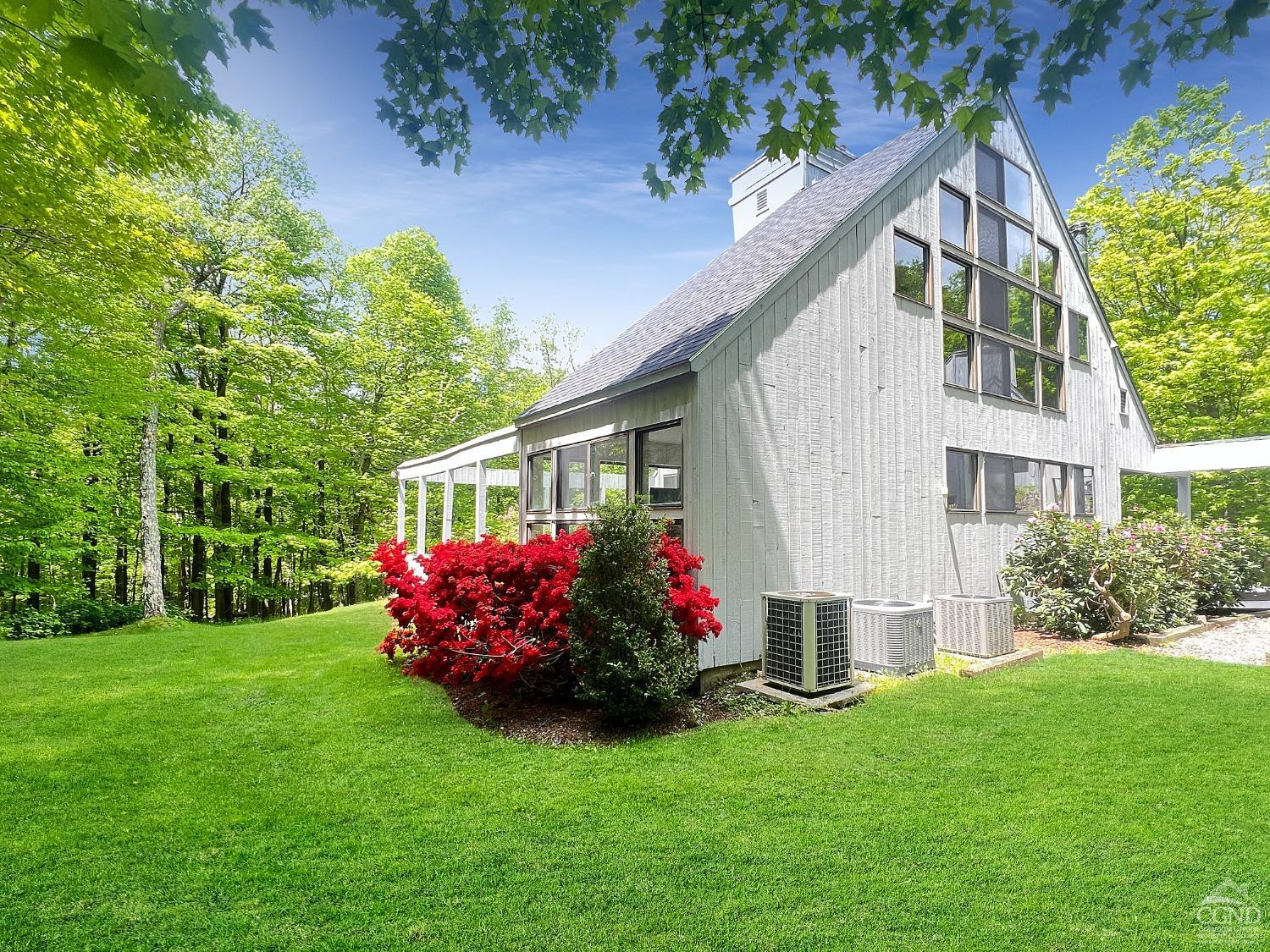 208 Cambridge Road Copake, NY 12529 - Photo 4 of 36 a front view of a house with a garden