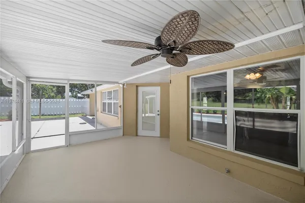 a view of an empty room and a ceiling fan