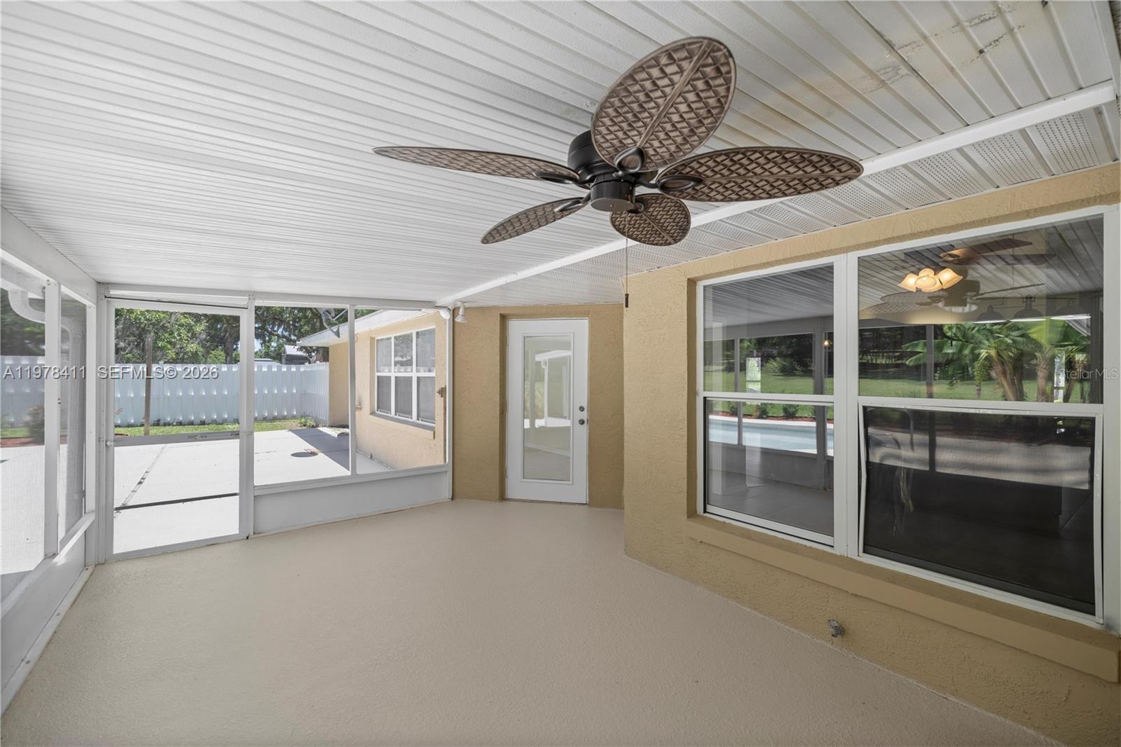 1699 Southwest 80th Street Ocala, FL 34476 - Photo 12 of 47 a view of an empty room and a ceiling fan