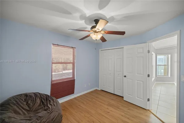 a bedroom with a bed and a chandelier fan