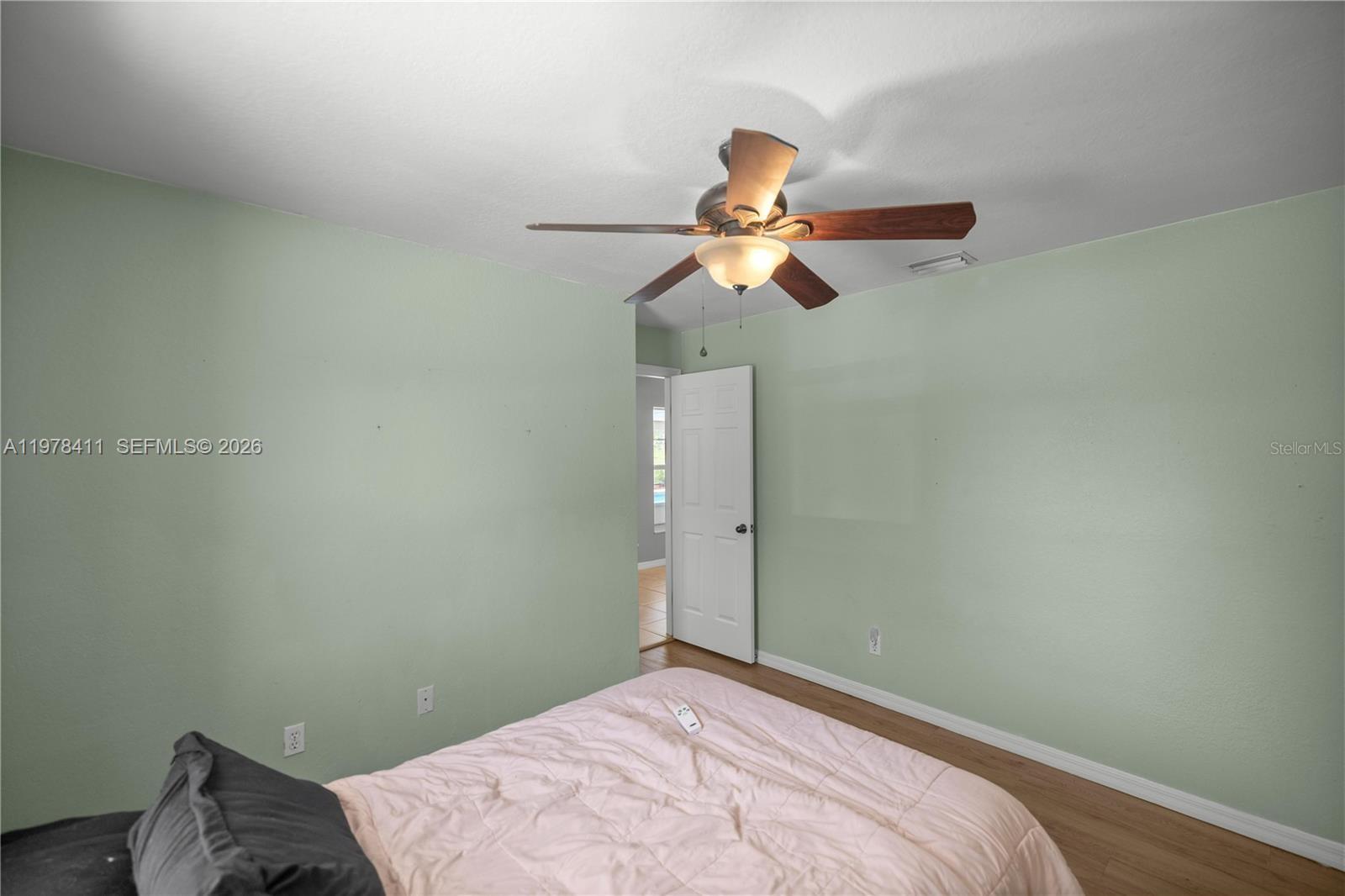 1699 Southwest 80th Street Ocala, FL 34476 - Photo 19 of 47 a bedroom with a fan and a bed