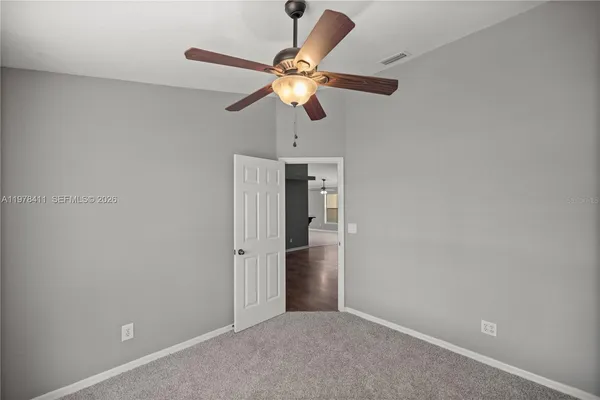 a view of a livingroom with a ceiling fan and window