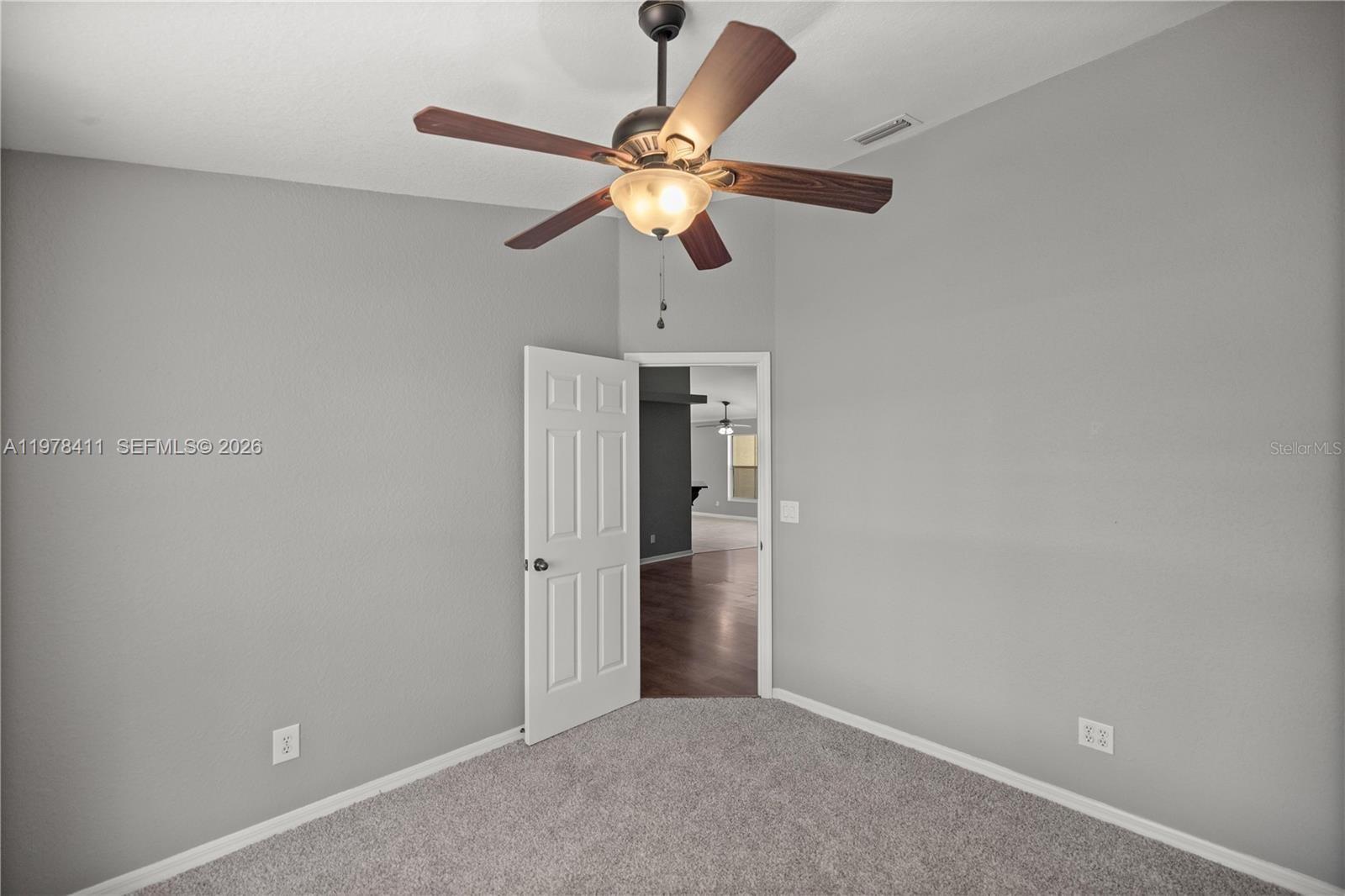 1699 Southwest 80th Street Ocala, FL 34476 - Photo 21 of 47 a view of a livingroom with a ceiling fan and window