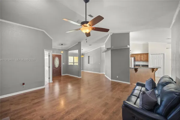 a view of a livingroom with furniture and a ceiling fan