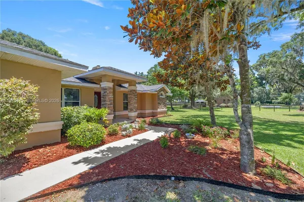 a front view of a house with garden