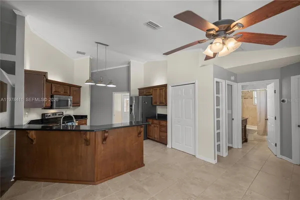 a kitchen with stainless steel appliances a refrigerator and a stove top oven