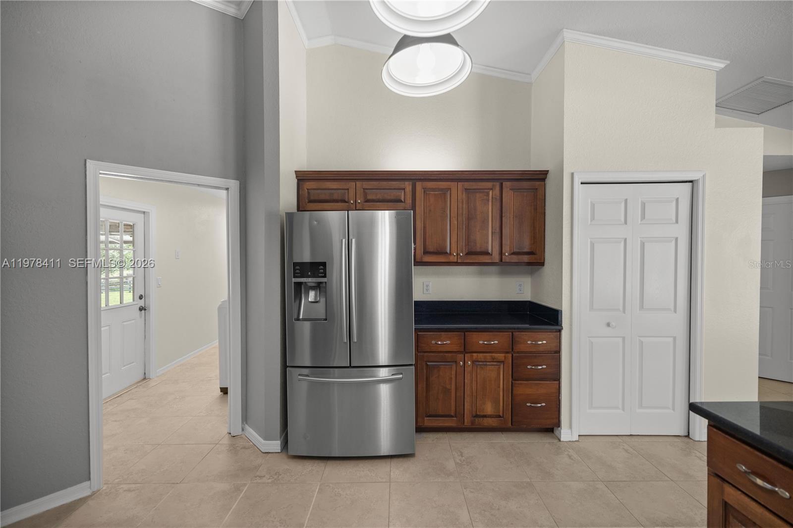 1699 Southwest 80th Street Ocala, FL 34476 - Photo 35 of 47 a kitchen with stainless steel appliances a refrigerator and a stove top oven