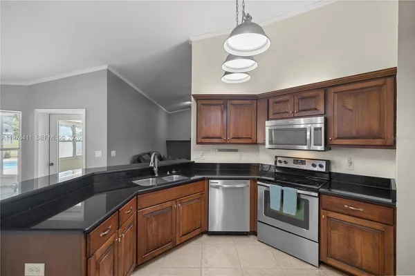 a spacious bedroom with a bed and a chandelier