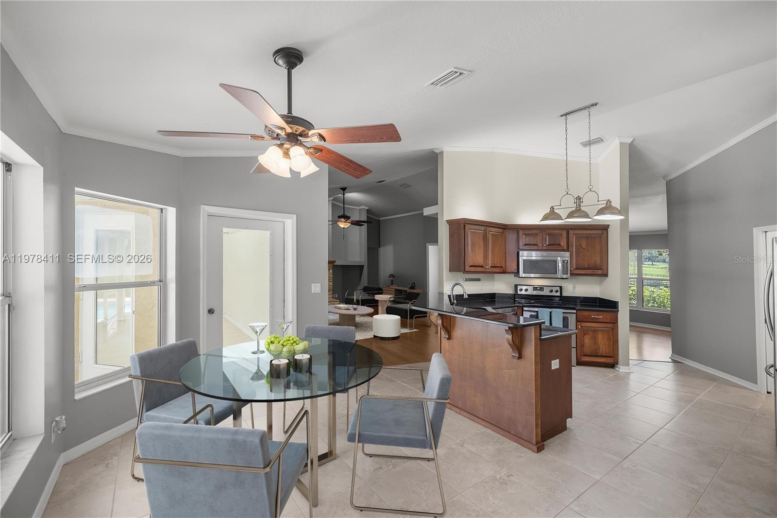 1699 Southwest 80th Street Ocala, FL 34476 - Photo 38 of 47 a dining room with furniture and wooden floor
