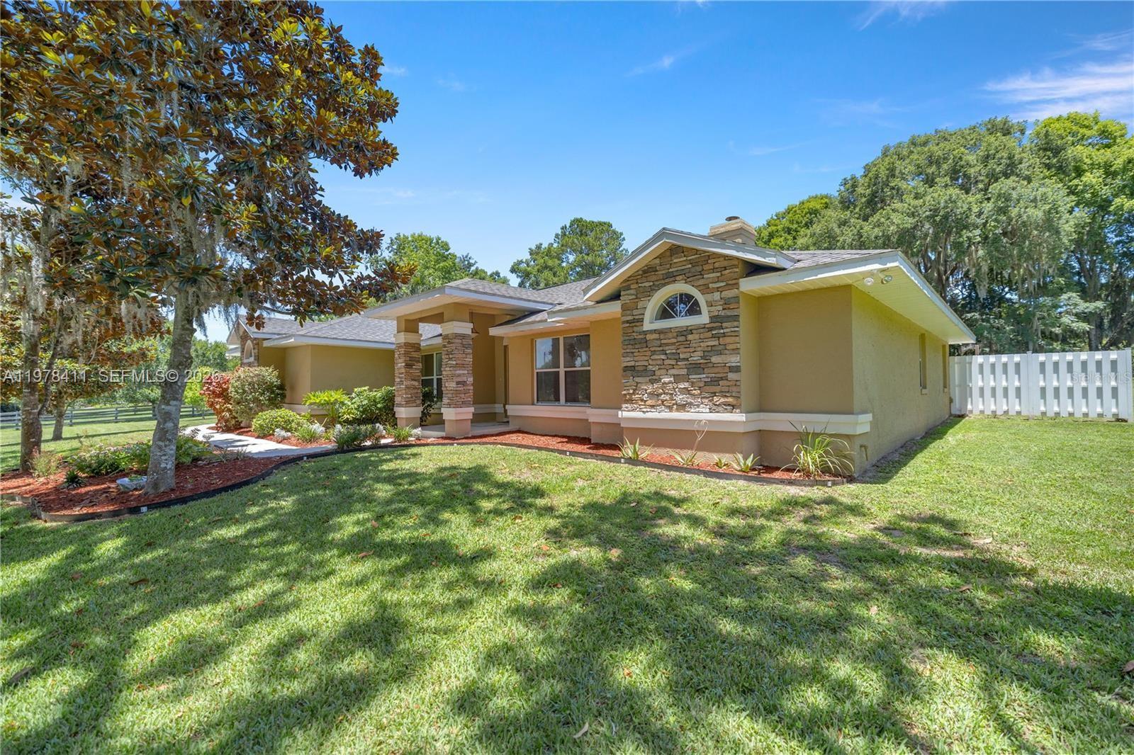 1699 Southwest 80th Street Ocala, FL 34476 - Photo 4 of 47 a front view of a house with garden