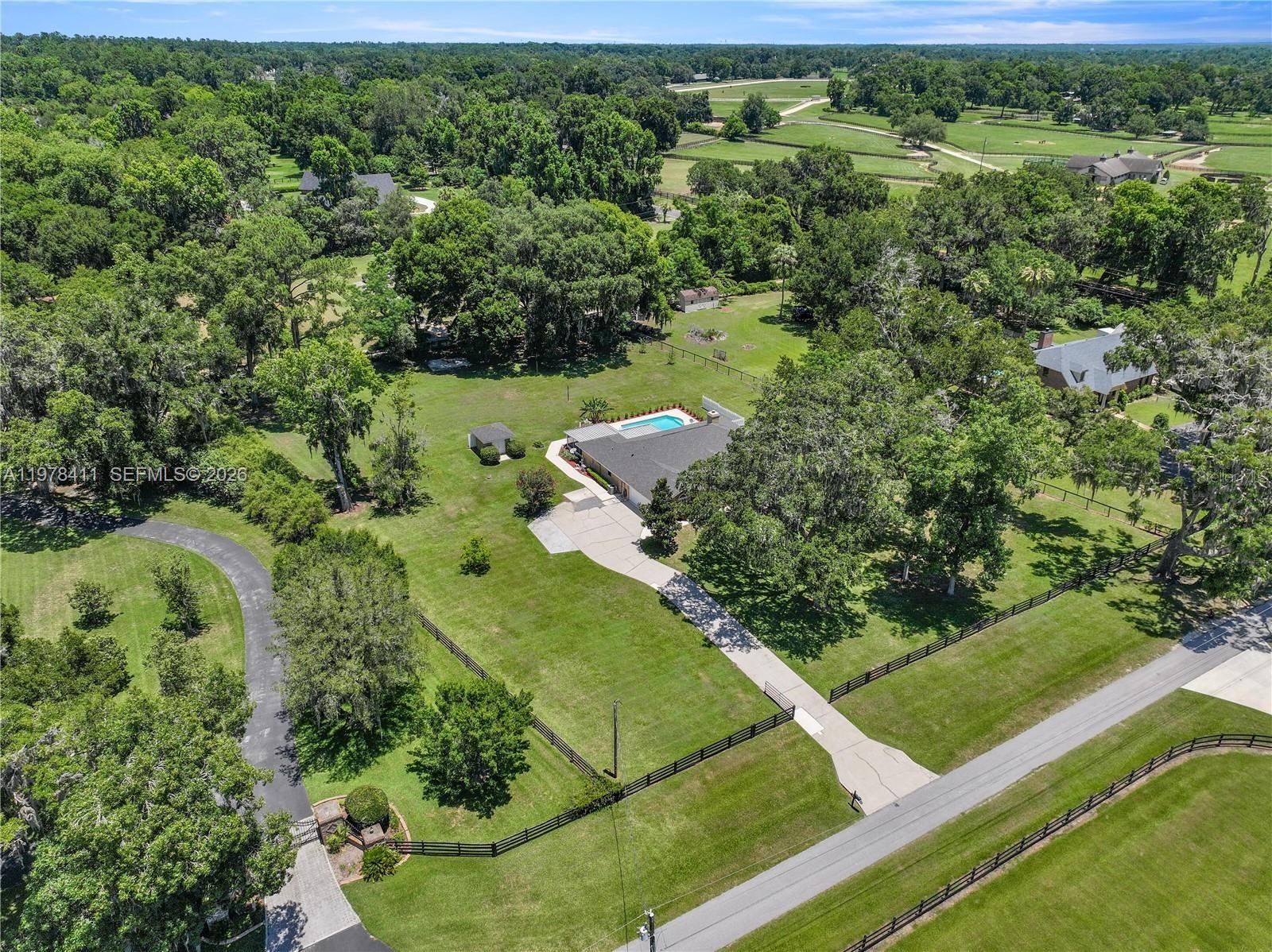 1699 Southwest 80th Street Ocala, FL 34476 - Photo 44 of 47 an aerial view of a residential houses with outdoor space and trees all around