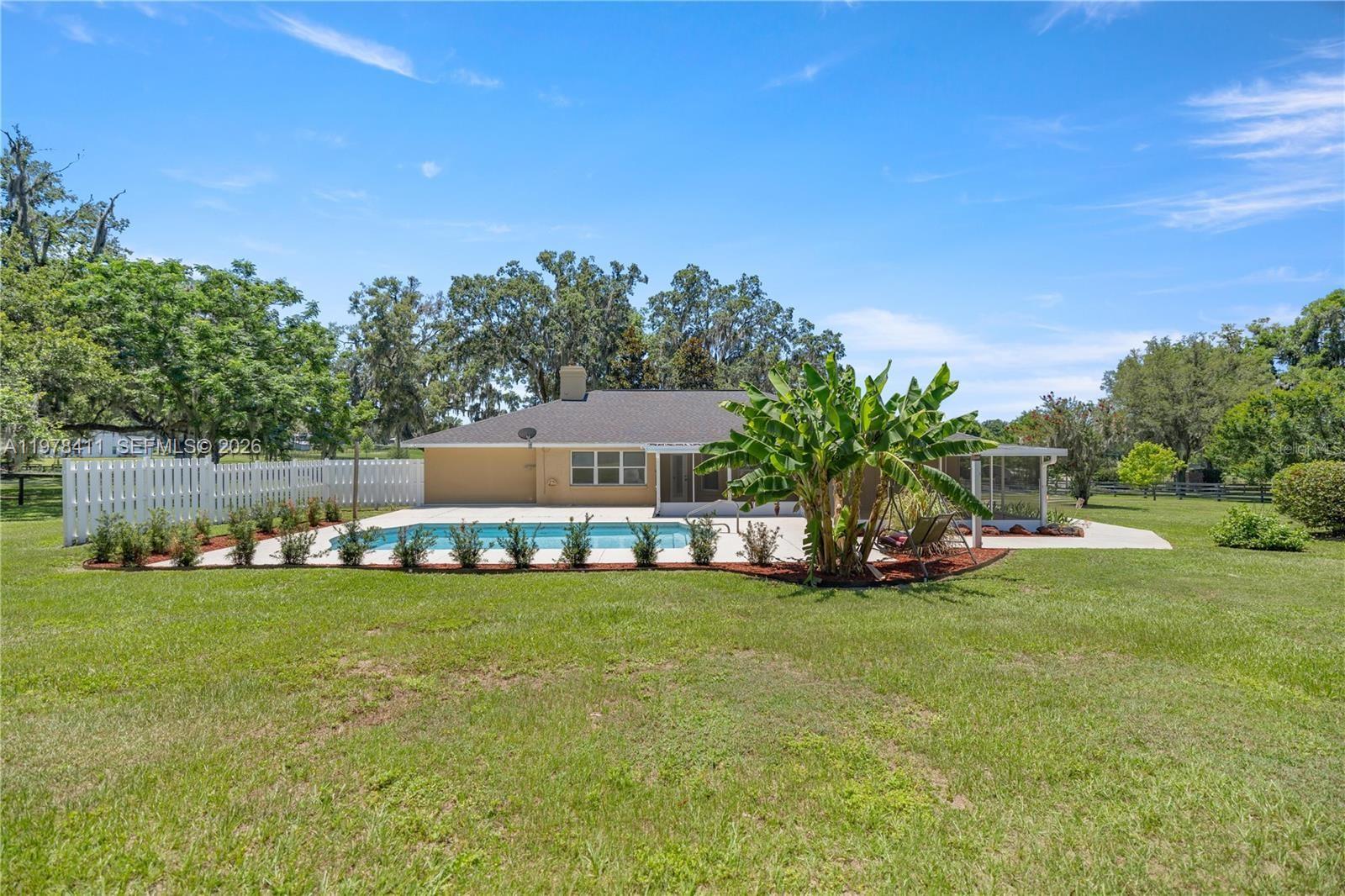 1699 Southwest 80th Street Ocala, FL 34476 - Photo 6 of 47 a view of a house with a big yard